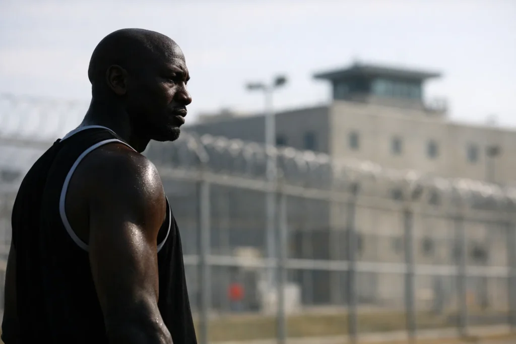 Michael Jordan prison investment fact check showing athlete silhouette and private prison facility in background