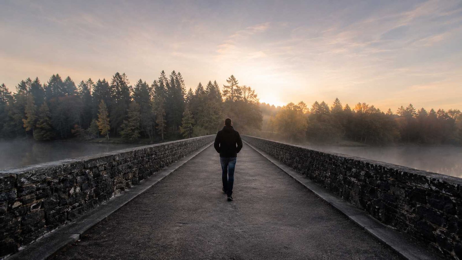 See You On The Other Side meaning represented by a person crossing a bridge toward the light.