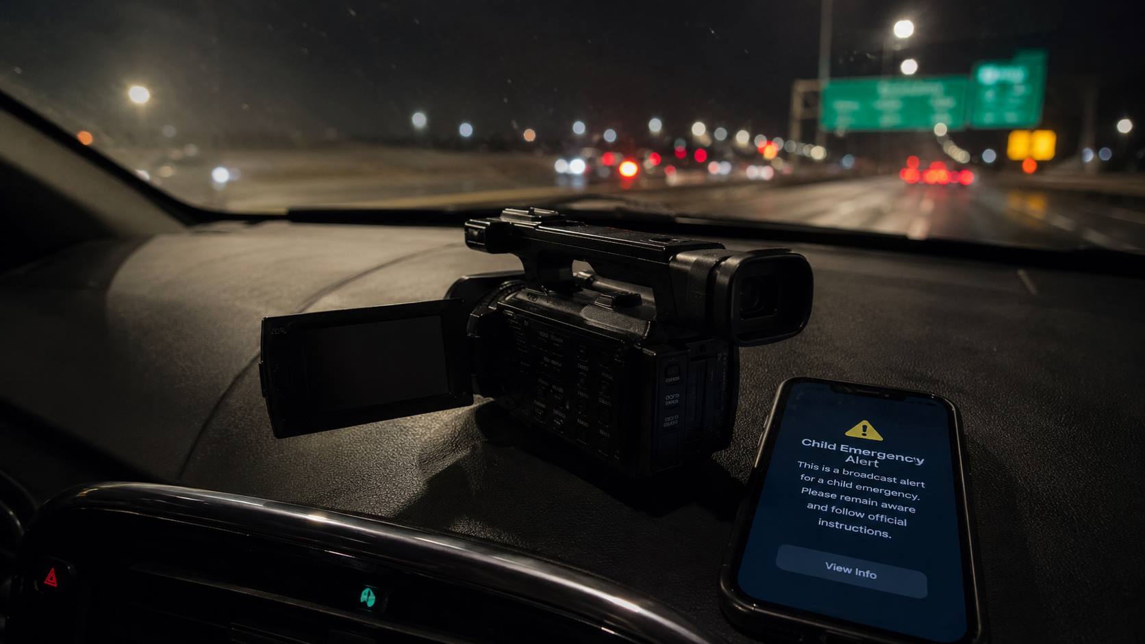 Handheld camera and emergency phone alert explaining whether the Amber Alert movie footage is real.